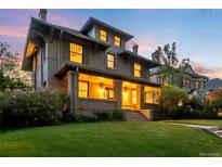 Charming two-story home with a spacious front yard, inviting entrance, and classic architectural details at 637 N Franklin St, Denver, CO 80218