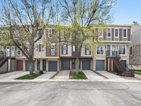 Charming townhomes with attached garages and mature trees line the street, showing appealing exterior features at 2578 E Nichols Cir, Centennial, CO 80122