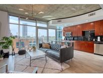 Open concept living room featuring floor-to-ceiling windows and modern kitchen with stainless appliances at 1700 Bassett St # 412, Denver, CO 80202