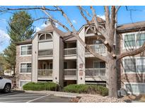 Charming condo exterior with multiple balconies and well-maintained landscaping on a sunny day at 9212 E Arbor Cir # E, Englewood, CO 80111