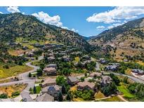 Stunning aerial view of the community nestled in the mountains with lush green trees and winding roads at 5368 Wildcat Ct, Morrison, CO 80465