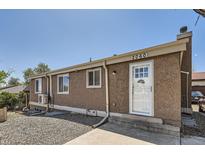 Cozy one-story home featuring a stucco exterior, front door, and well-maintained landscaping at 2060 W Iliff Ave, Englewood, CO 80110
