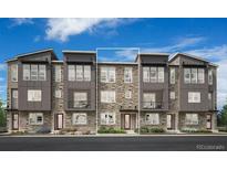 Modern townhome with stone accents and a welcoming entrance, set against a blue sky at 6285 N Kirk St, Aurora, CO 80019