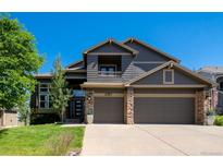 Charming two-story home featuring a three-car garage, stone accents and a private balcony, perfect for enjoying the outdoors at 6787 Serena Ave, Castle Pines, CO 80108