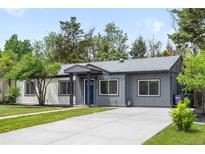 Charming single-story home featuring a well-maintained lawn and a long driveway at 3065 S Eudora St, Denver, CO 80222