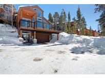 Stunning home with a balcony and a garage, surrounded by snow at 160 N Fuller Placer Rd, Breckenridge, CO 80424