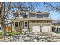Charming two-story home with a brick facade, dormer windows and a two car garage at 3803 Dyanna Dr, Thornton, CO 80241
