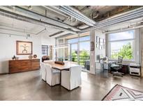 Bright living room featuring concrete floors, large windows offering views, and an open layout design at 1610 Little Raven St # 302, Denver, CO 80202