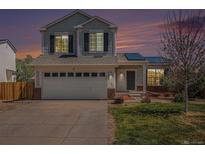 Charming two-story home with a well-manicured lawn, solar panels, and an attached two-car garage at 3543 S Ceylon Way, Aurora, CO 80013