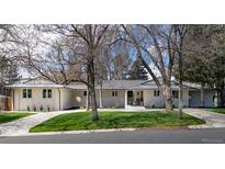 Stunning single story exterior featuring a well maintained lawn and mature trees in front at 3901 S Dexter St, Cherry Hills Village, CO 80113