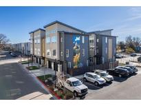 Modern townhome exterior featuring contemporary design, a mountain mural and convenient parking at 5227 N Eliot St, Denver, CO 80221