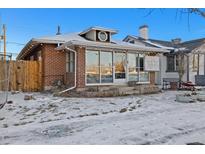 Brick building with large windows, steps, and small yard at 2469 S Broadway, Denver, CO 80210