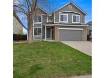 Charming two-story home with well-manicured lawn, gray siding, stone accents, and attached two car garage at 510 Fairhaven St, Castle Rock, CO 80104
