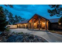 Charming brick home with a three-car garage and covered front porch at 12570 W 60Th Ave, Arvada, CO 80004