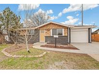 Charming single-story home featuring stone and brick accents, a well-maintained yard, and a single-car garage at 8481 Clarkson St, Denver, CO 80229