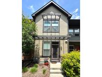 Charming two-story home featuring a welcoming front door and well-manicured landscaping at 3584 Central Park Blvd, Denver, CO 80238
