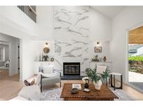Bright living room boasts a modern fireplace, built-in cabinets, and lots of natural light at 5944 E Irwin Pl, Centennial, CO 80112