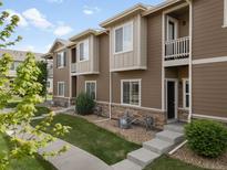 Charming townhome featuring a well-maintained lawn and a welcoming facade at 1456 Sepia Ave, Longmont, CO 80501