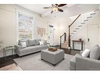 Bright living room featuring a comfortable seating area, ceiling fan and staircase to the second floor at 1020 Kalamath St, Denver, CO 80204