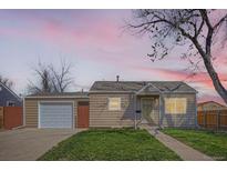 Charming single-story home featuring a well-maintained lawn and detached garage, perfect for first-time homebuyers at 1480 S Osceola St, Denver, CO 80219