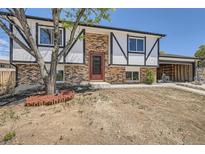 Charming brick home with a two-car garage, black and white trim, and a landscaped front yard at 17979 E Oxford Pl, Aurora, CO 80013