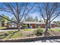 Charming brick home with mature trees and well-maintained landscaping, perfect for outdoor living at 5882 S Sheridan Blvd, Littleton, CO 80123