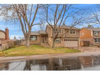 Inviting two-story home with well-kept lawn and attached two-car garage at 2038 S Hoyt Way, Lakewood, CO 80227
