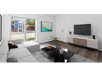 Bright living room features modern decor, sleek furniture, and hardwood floors at 7220 S Gaylord St # G17, Littleton, CO 80122