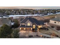 A beautiful two-story home with a three-car garage and well-maintained landscaping sits on a large lot at 948 Buffalo Ridge Rd, Castle Pines, CO 80108