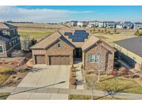 Beautiful stone home with solar panels and a three-car garage in a well-kept neighborhood at 27655 E Moraine Dr, Aurora, CO 80016