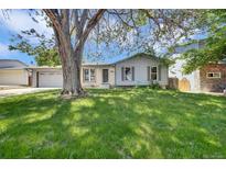 Charming single-story home featuring mature trees and a well-manicured lawn in a suburban neighborhood at 2279 S Lewiston St, Aurora, CO 80013