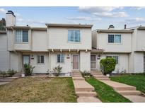Charming townhome featuring a well-maintained lawn and a welcoming entrance with concrete steps and neutral-colored siding at 4117 S Mobile Cir # C, Aurora, CO 80013