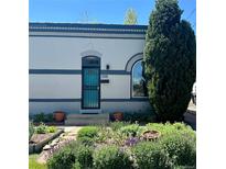 Charming home featuring a well-kept front garden and a turquoise-colored security door at 320 E Dakota Ave, Denver, CO 80209