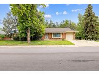 Charming single-story brick home with mature shade trees and an attached one car garage at 13493 E Dakota Ave, Aurora, CO 80012