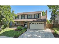 Charming two-story home with landscaped yard, brick accents, and two-car garage at 1121 W Kettle Ave, Littleton, CO 80120