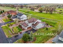 Sprawling home featuring a 4-car garage and views of green pastures and mature trees at 42225 Kingsmill Cir, Elizabeth, CO 80107