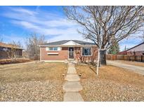 Charming brick home with a well-maintained front yard and inviting walkway at 11052 Rosalie Dr, Northglenn, CO 80233
