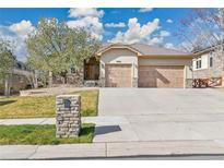 Charming single-story home featuring a two-car garage, stone accents, and manicured front yard at 2885 W 115Th Dr, Denver, CO 80234