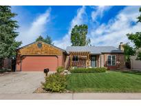 Charming home showcasing a well-manicured lawn and beautiful landscaping, perfect for outdoor enjoyment at 17372 E Prentice Cir, Centennial, CO 80015