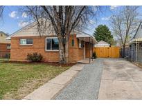 Charming brick home featuring a well-maintained yard and inviting entrance at 3550 Fairfax St, Denver, CO 80207
