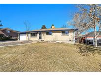 Charming brick home with a well-maintained front yard and a detached one-car garage at 3175 W Stanford Ave, Englewood, CO 80110