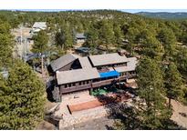 Sprawling mountain home with a backyard bocce court and wooded surroundings at 2851 Interlocken Dr, Evergreen, CO 80439