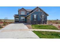Charming two-story home with stone accents, attached garage, and well-manicured lawn at 8086 S Grand Baker Way, Aurora, CO 80016
