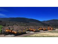 Scenic view of a community against a stunning mountain backdrop under a starry night sky at 4502 Echo Cliff Ln, Larkspur, CO 80118