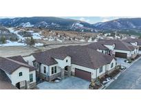 Stunning stucco home with stone accents, a spacious driveway, and beautiful mountain views at 4502 Echo Cliff Ln, Larkspur, CO 80118