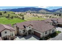 Beautiful exterior of a house with mountain views and a well-manicured lawn in a serene neighborhood at 4502 Echo Cliff Ln, Larkspur, CO 80118