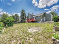 Expansive backyard features a lawn and a deck, ideal for outdoor gatherings and relaxation at 778 S Fairplay Ct, Aurora, CO 80012