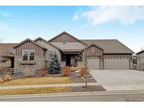 Charming single-Gathering home with stone accents, well-maintained landscaping, and a spacious three-car garage at 8000 Gore Creek Ln, Littleton, CO 80125