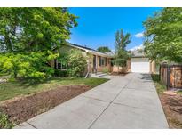 Charming brick home featuring a long driveway, attached garage, and well-manicured front yard at 216 Hemlock, Broomfield, CO 80020