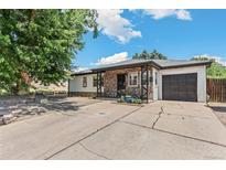 Charming single-story home featuring stone accents, a well-manicured lawn and a driveway leading to a one-car garage at 1680 S Patton Ct, Denver, CO 80219